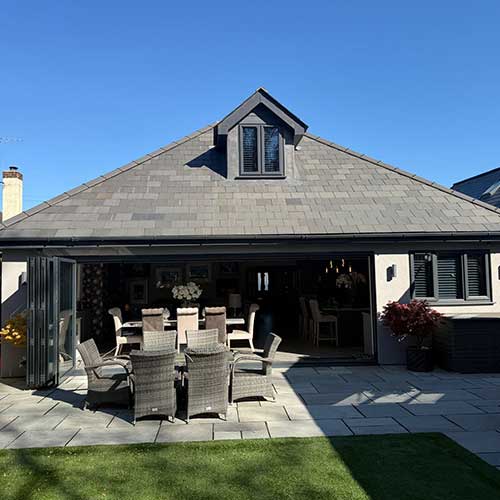 Rear extension with bi-fold doors opening onto porcelain patio