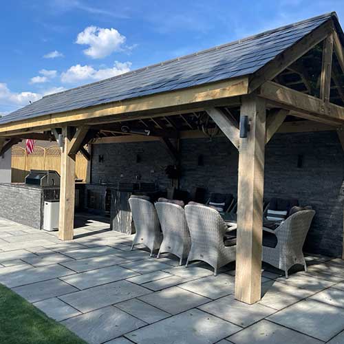Timber garden room with built-in barbecue kitchen and paved patio
