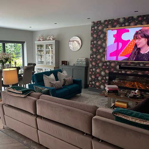 Open-plan living and dining room with bi-fold doors to garden