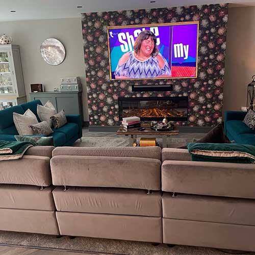 Living room with fitted media wall and inset electric fireplace