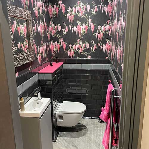 Cloakroom with wall-hung toilet, basin and metro tiling