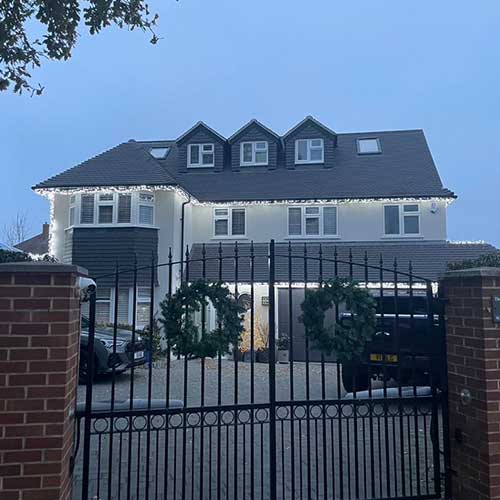Rendered detached house with dormer loft conversion at dusk