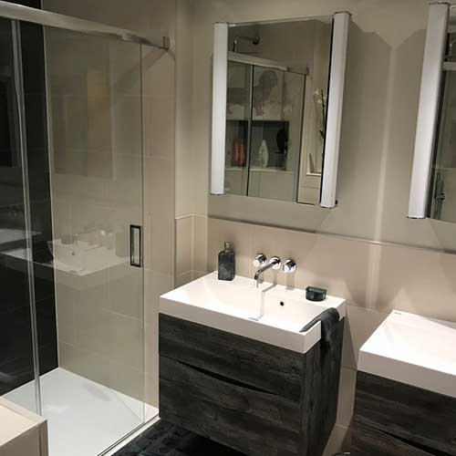Modern bathroom with twin basins and glazed shower enclosure