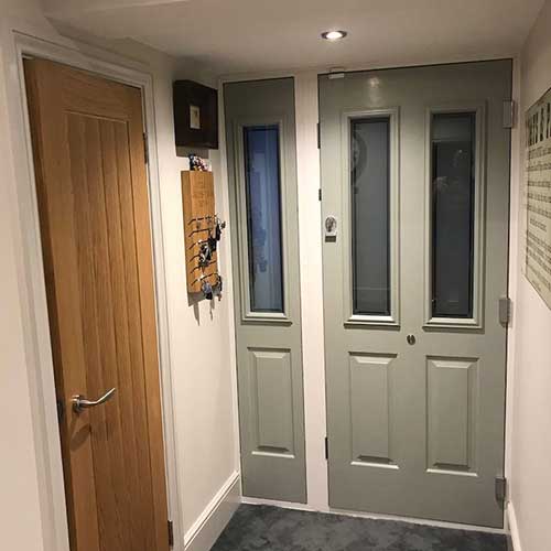 Fitted composite front door and oak internal door in hallway