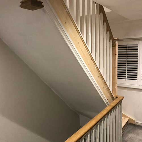 New timber staircase and landing with plastered walls and shutters