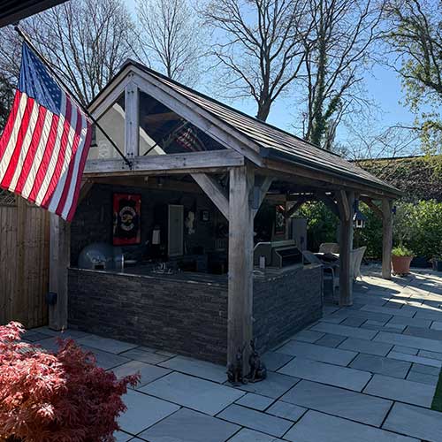 Finished oak-framed outdoor kitchen and bar on sandstone patio