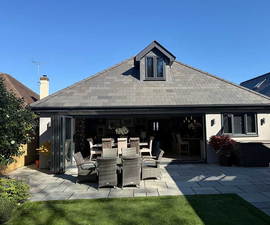 Rear extension with bifold doors opening onto a porcelain patio