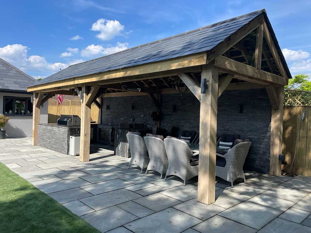 Oak framed garden room with a built in barbecue kitchen and paved patio