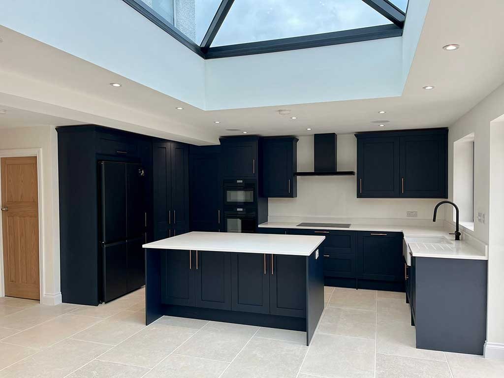 Navy kitchen with an island beneath a lantern roof
