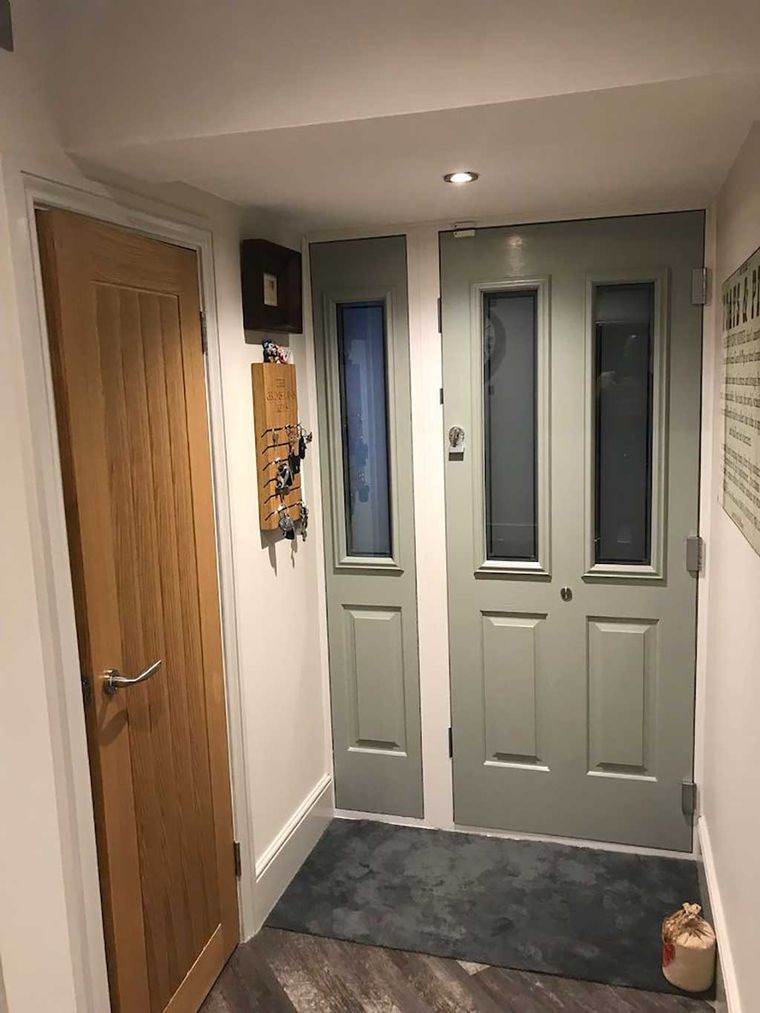 Fitted composite front door and oak internal door in a hallway