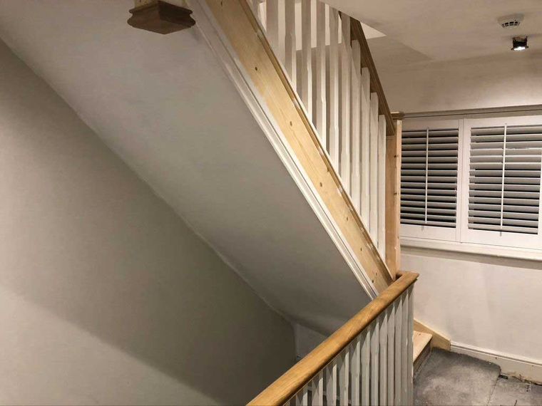 New timber staircase and landing with plastered walls and shutters