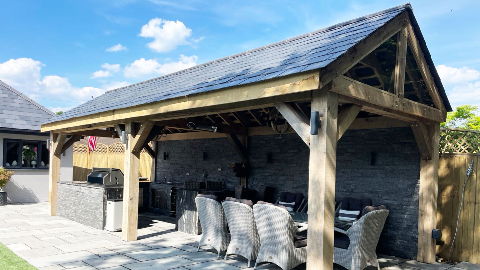 Oak framed garden room with a built in barbecue kitchen and paved patio